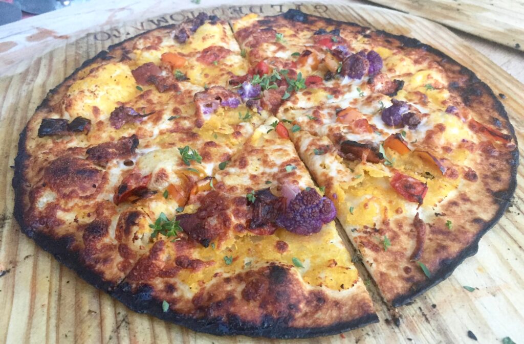 Purple cualiflower tops a veggie pizza catered by the Gilded Tomato Company